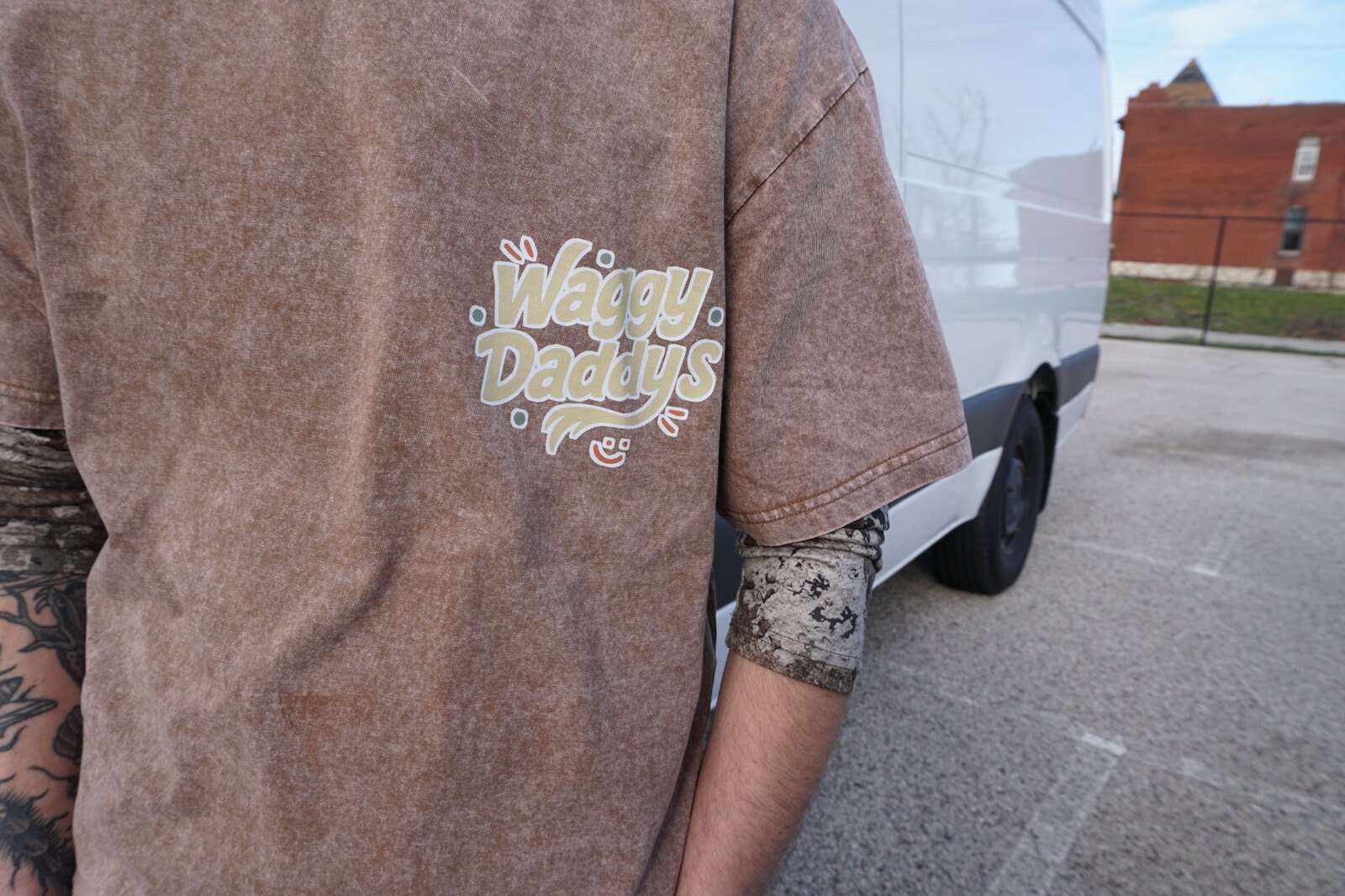 Waggy Daddys shirt logo with the grooming van behind it